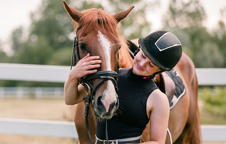 woman-in-black-petting-horse