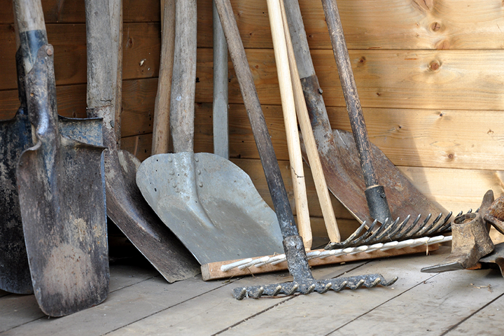 Close up of garden tools stored in a garden shed, a hazard to pets 